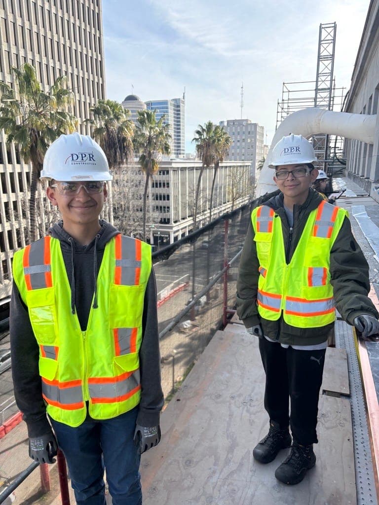 Two CCCA Works! student interns in safety gear at a construction job site